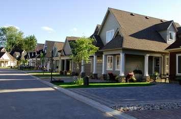 Modern single family homes on a new street. © Can Stock Photo / Pichunter