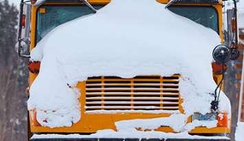 A school bus covered in snow. File photo courtesy of © Can Stock Photo / PiLens.