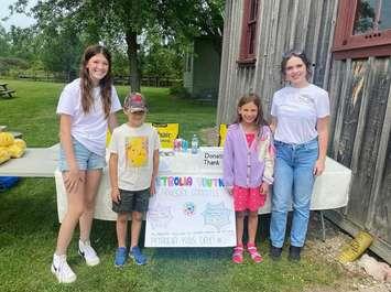 Youth Advisory Committee members Adelaide Close and Ava Horwood speak with children at Petrolia Kids Day. Submitted photo.