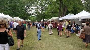 Attendees visit vendors for the 2013 edition of  Art in the Park.