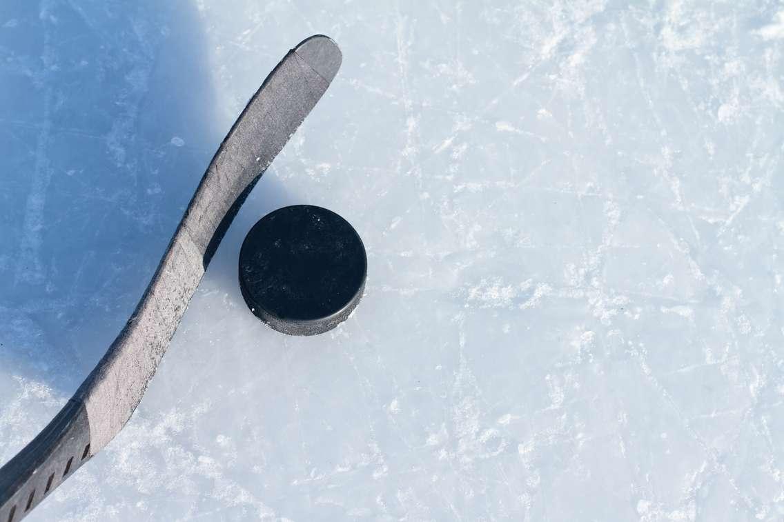 Hockey stick and a puck. © Can Stock Photo / bradcalkins