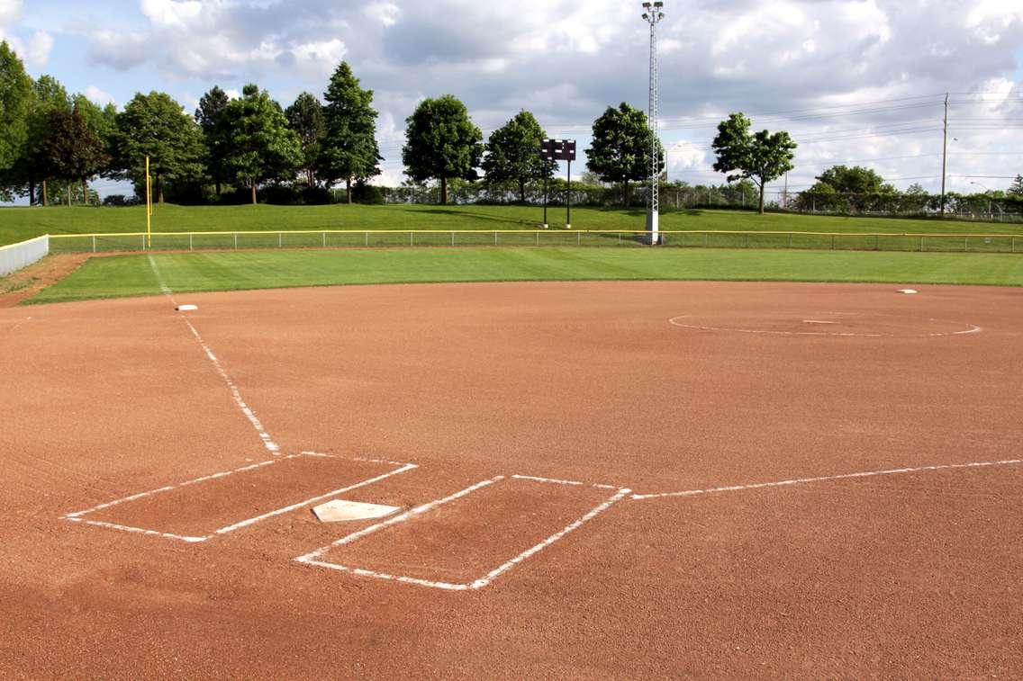 A view of a softball diamond at dusk. © Can Stock Photo / ca2hill