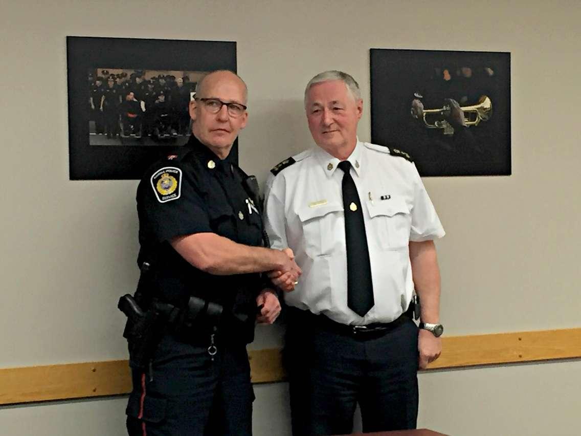 Police Chief Phil Nelson presents the retiring Constable Les Jones with the 'Chief's Coin'. January 28, 2016 (BlackburnNews.com Photo by Briana Carnegie)