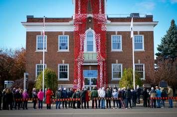 Poppies flow from the tower at the Municipal Office in Strathroy-Caradoc. The poppy design is a trademark of The Royal Canadian Legion (Dominion Command). Image courtesy of the Municipality of Strathroy-Caradoc Facebook page.