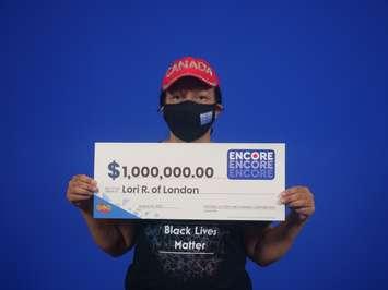 Lori Reive of London holding up her $1-million cheque after winning with Encore on a May 2022 Lotto Max ticket. (Photo supplied by OLG).