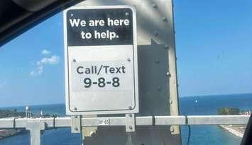9-8-8 sign installed at the Blue Water Bridge. Image captured from the Sarnia-Lambton Suicide Prevention Facebook page. Photo by Ashley Marsden.