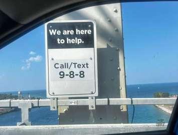 9-8-8 sign installed at the Blue Water Bridge. Image captured from the Sarnia-Lambton Suicide Prevention Facebook page. Photo by Ashley Marsden.
