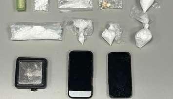 Phones, cash and drugs seized at an Elgin Street home (Photo by: Sarnia police)