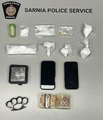 Phones, cash and drugs seized at an Elgin Street home (Photo by: Sarnia police)