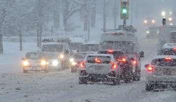 Vehicles travel on a snow covered road. (File photo by Miranda Chant, Blackburn Media)