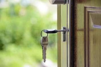 Keys in a house door for rent or home sale stories.