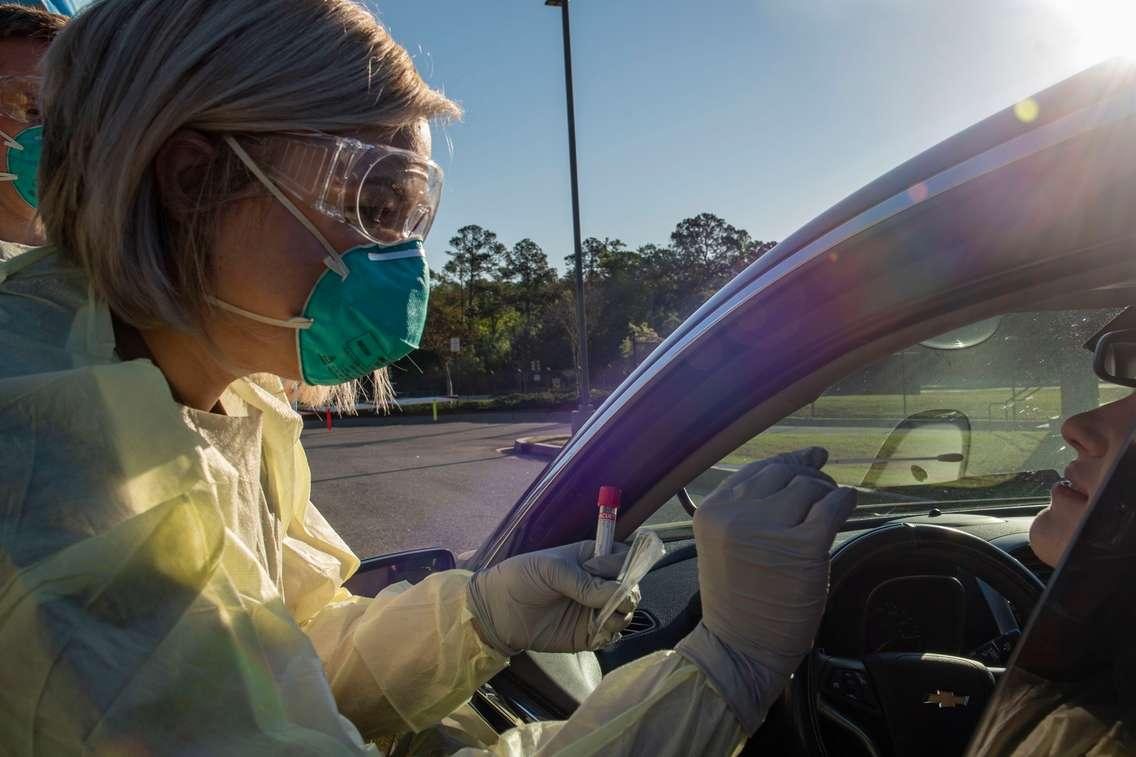 Tech. Sgt. Alexandra McElwain performs a nasal swab on an active duty Airman during a COVID-19. April 1, 2020. (U.S. Air Force photo by Airman 1st Class Azaria E. Foster)