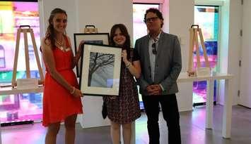 Isis Belleman-McKeegan (center) is awarded the grand prize for the 2024 Teen Photo Contest by Vanitia Campbell (left) and Richard Beland (right) (Photo by: County of Lambton)