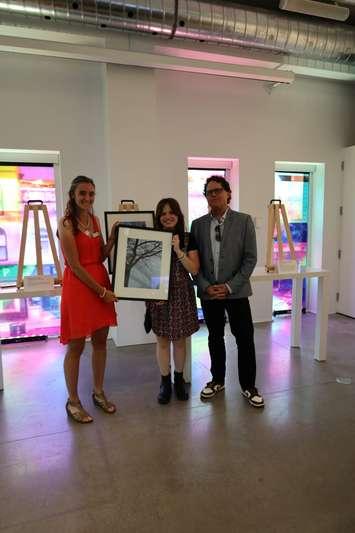 Isis Belleman-McKeegan (center) is awarded the grand prize for the 2024 Teen Photo Contest by Vanitia Campbell (left) and Richard Beland (right) (Photo by: County of Lambton)