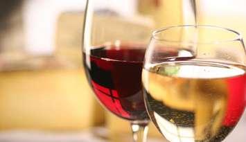 Glasses of red and white wines. File photo courtesy of © Can Stock Photo / fredredhat.