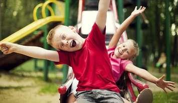 Children playing on the playground. File photo courtesy of © Can Stock Photo / gpointstudio