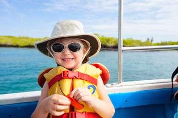 A young child on a boat in a lifejacket. Photo by shalamov/ iStock via Getty Images Plus.