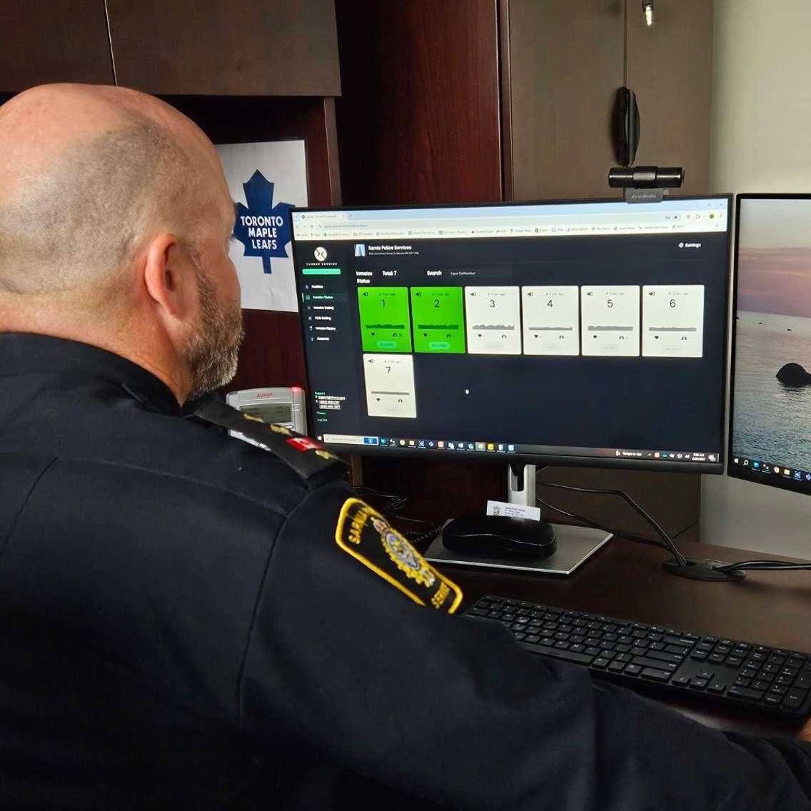 Insp. Michael Van Sickle looking at the new biometric monitoring system (Photo by: Sarnia police)