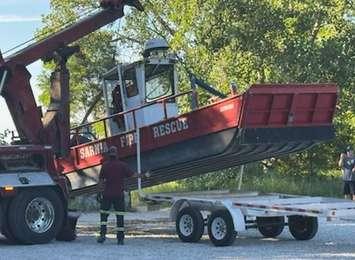 A worker with Preferred Towing lifts Marine 1 onto a trailer after retrieving the vessel from the Lake Huron shoreline. July 21, 2025 Submitted photo.