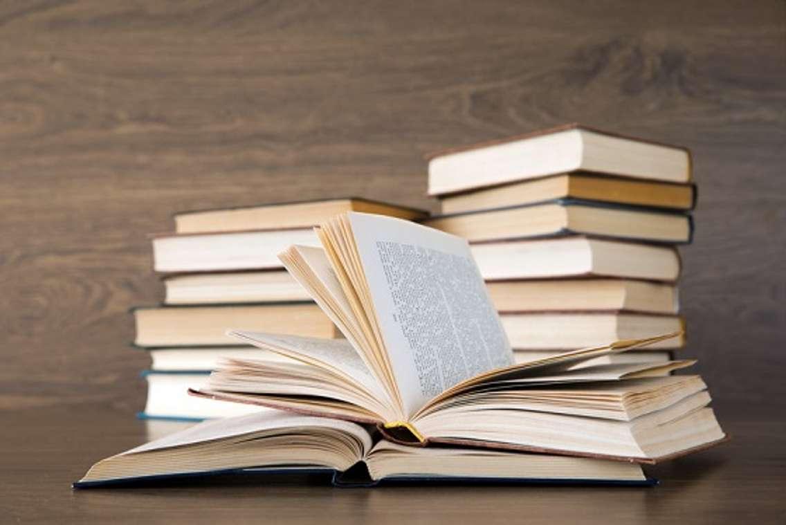 A stack of books sitting on a table. File photo courtesy of © Can Stock Photo / Pakhnyushchyy.