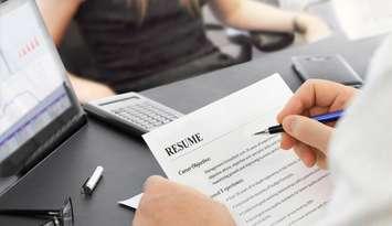 Job interview in the office with focus on resume and pen.  © Can Stock Photo / nan104