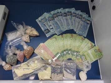 Drugs and cash seized after a search on Park Street in Chatham. (Photo courtesy of Chatham-Kent police)