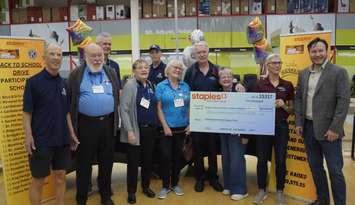 Local Kiwanis club members and Staples staff celebrating money raised for back to school. (Photo by: Lindsay Newman/ Blackburn Media)