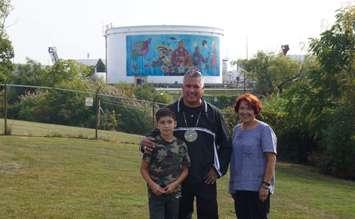 Artist John Williams and his son, with Joanne Rogers of Aamjiwnaang First Nation. September 16, 2022. (Photo by Natalia Vega)