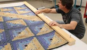 Lambton Heritage Museum prepares quilts for hanging in the 2025 North Lambton Quilters’ Guild Quilt Show. Submitted photo.  -------------------------------------