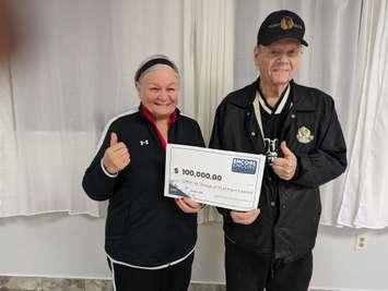 Clifton Wasson (R) of Point Edward and Linda Chivers (L) of Sarnia celebrate a $100,000 ENCORE win - Nov 15/23 (Photo courtesy of OLG)