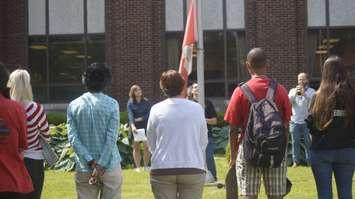 Students and staff gather for a symbolic lowering of the flag at the former SCITS high school on Wellington Street. June 19, 2019 Photo by Melanie Irwin