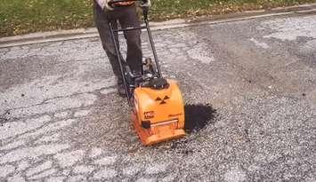 Sarnia Public Works Department staff use equipment to compress hot asphalt to fix a pothole. Image courtesy of Sarnia City Councillor George Vandenberg. 