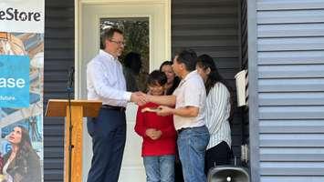 Donald Haagsma turns over keys to the Lopez family. May 30, 2022. (Photo courtesy of Habitat for Humanity Sarnia-Lambton)