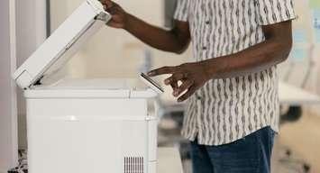 A person using a printer. Photo provided by the Bruce County Public Library. 