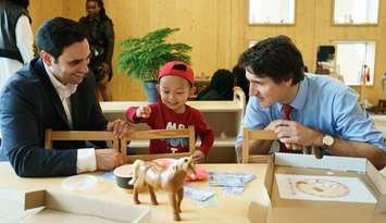 London North Centre MP Peter Fragiskatos and Prime Minister Justin Trudeau with a small child at the Stationview YMCA Child Care Centre in St. Thomas, May 13, 2024. Photo from @pfragiskatos on X.