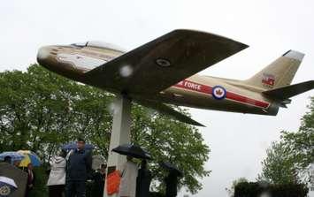 Mike Bradley and Chris Hadfield look on as a plaque is unveiled rededicating the Golden Hawk at Germain Park May 31,2015 (BlackburnNews.com photo by Dave Dentinger)