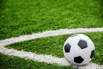 A soccer ball on a field. © Can Stock Photo / anekoho