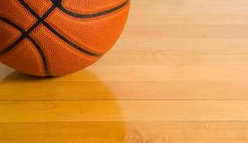 A basketball on a gym floor. © Can Stock Photo / mflippo