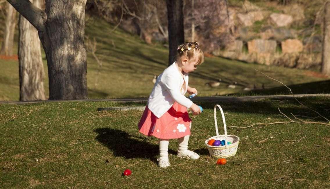 Little girl looks for Easter eggs. Photo courtesy of © Can Stock Photo / urbanlight