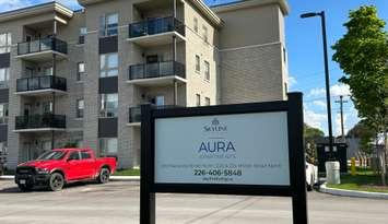 Aura Apartments sign. May, 2025. Blackburn Media Inc. photo by Lindsay Newman.