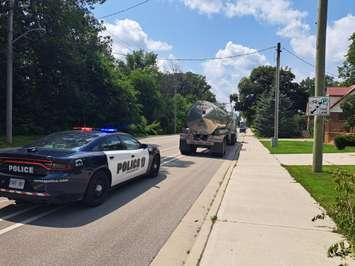 A Sarnia Police officer pulls over a large commercial vehicle illegally cutting through the city. July 2023. (Photo by Sarnia Police Service)