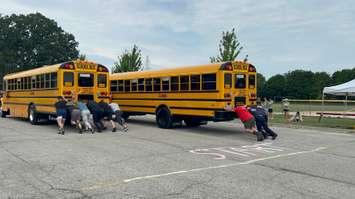 Two teams participating in the Push The Bus event on July 11, 2025 (Photo by: Lindsay Newman/ Blackburn Media)