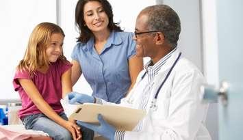 Doctor examining young girl. Photo by monkeybusinessimages/iStock via Getty Images Plus