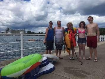 Fort Gratiot resident Jeanne Gardner waits with family and friends for a cab, after ending up in Canada while participating in the Pt. Huron float down. August 21, 2016 BlackburnNews.com photo by Melanie Irwin.