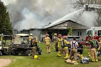 Firefighters battle a fire in a storage and maintenance shop at Caradoc Sands Golf Club in Strathroy, May 16, 2023. Photo from Caradoc Sands Facebook page.
