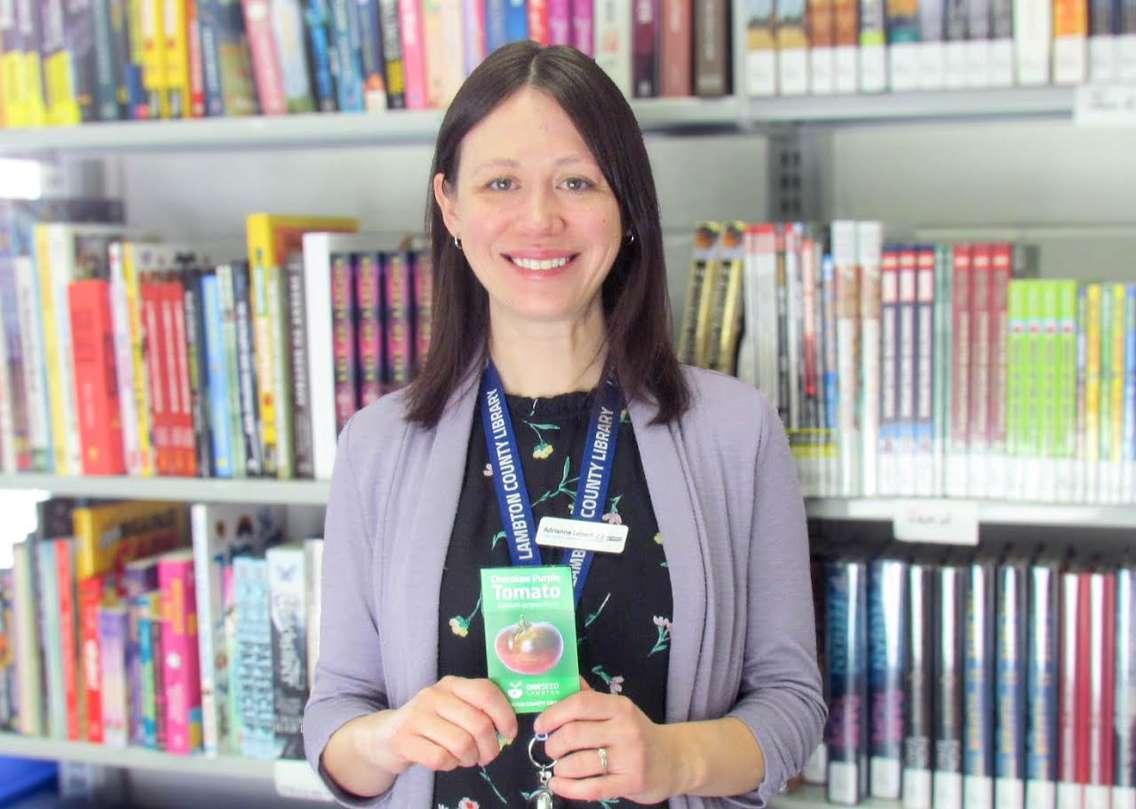 Public Services Coordinator Adrianne Lebert, displays a One Seed Lambton tomato seed packet, available for free at all Lambton County Library locations. Submitted photo. 