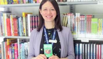 Public Services Coordinator Adrianne Lebert, displays a One Seed Lambton tomato seed packet, available for free at all Lambton County Library locations. Submitted photo. 