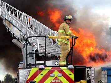 A firefighter puts out a fire at the U Haul storage facility on Confederation Street (Sept 13/23)