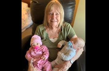 North Lambton Lodge resident Phyllis Hodge holds rocking chair therapy dolls. 2022. Submitted photo.