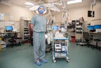 Dr. Anton Skaro beside the pump technology. Photo provided by London Health Sciences Centre.